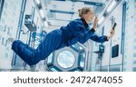 Astronaut Floating in Zero Gravity on Board a Spacecraft. Female Having a Video Call with a Family or Friends From Planet Earth. Engineer Using Smartphone in Space Inside an Orbiting Spaceship