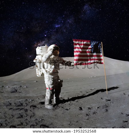Astronaut holding an American flag on moon surface with the stars and outer space on the background. Elements of this image furnished by NASA.