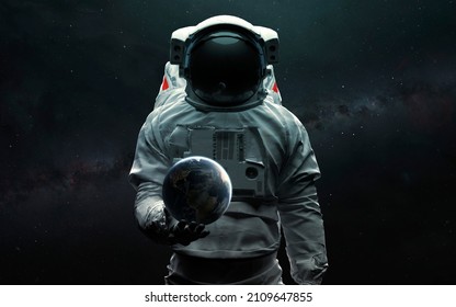Astronaut holding Earth planet in hand. 3D sci-fi art. Elements of image provided by Nasa