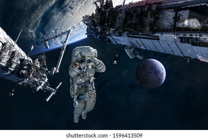 Astronaut, ISS In Orbit Of Earth. Moon. Solar System. Science Fiction. Elements Of This Image Furnished By NASA