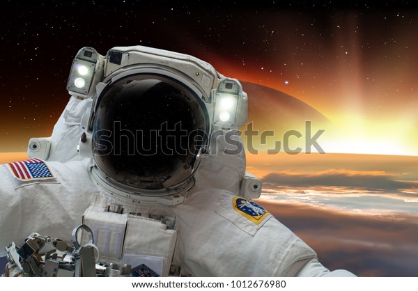 An astronaut\
making selfie over Earth background against Solar eclipse\
\