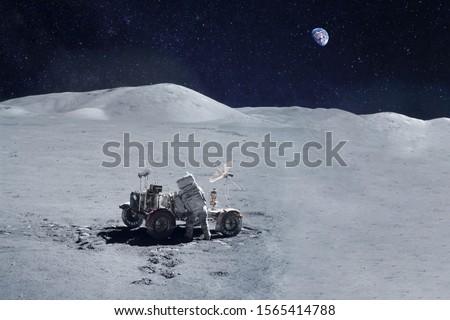 Astronaut near the moon rover on the moon. With land on the horizon. Elements of this image were furnished by NASA.