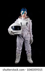 Astronaut on a black background, a young woman with face art in the space suit.