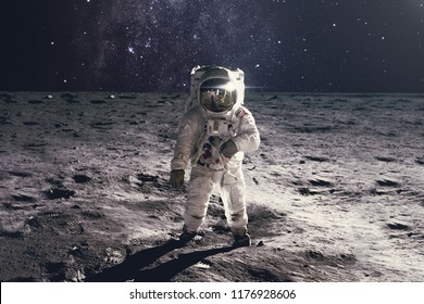 Astronaut on rock surface with space background. Elements of this image furnished by NASA - Shutterstock ID 1176928606