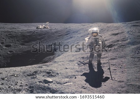 Astronaut on rock surface with space background. Elements of this image furnished by NASA