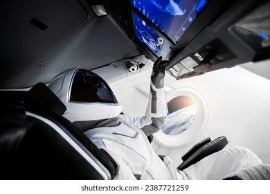 Astronaut on a spaceship flying in outer space. Elements of this image furnished by NASA.