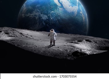 Astronaut on the surface of Moon. Planet Earth on the background. Apollo space program. Elements of this image furnished by NASA.