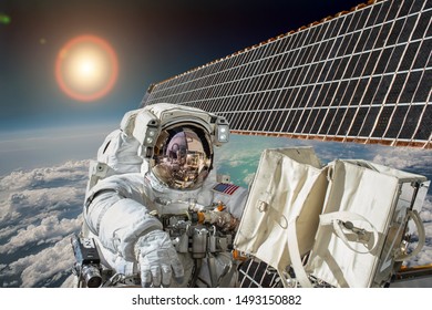 Astronaut in outer space against the backdrop of the planet earth. Elements of this image furnished by NASA.