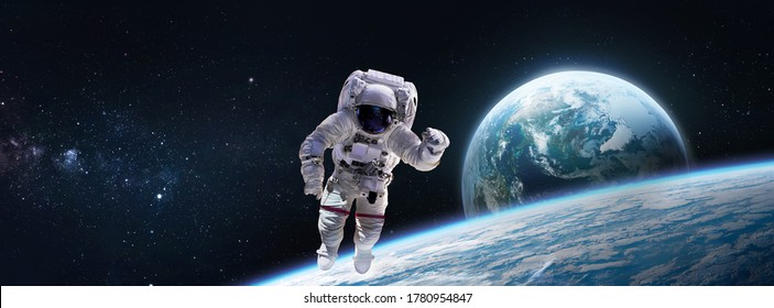 Astronaut In Outer Space Ob Orbit Of Planet Earth. ISS Expedition. Wide Resolution Wallpaper. Elements Of This Image Furnished By NASA