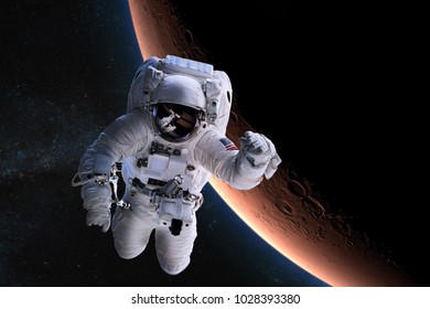 Astronaut in outer space on background of the Mars. Elements of this image furnished by NASA.