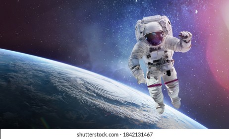 Astronaut In Outer Space On Orbit Of Earth Planet. Spaceman Floating In Deep Space. Elements Of This Image Furnished By NASA