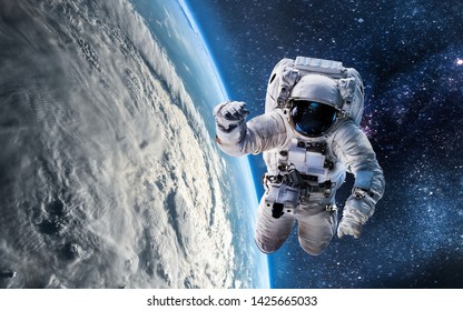 Astronaut In Outer Space Over The Planet Earth. View From ISS. Elements Of This Image Furnished By NASA