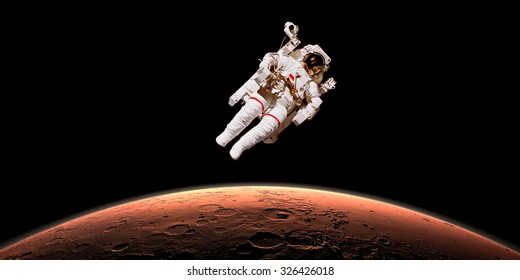 Astronaut In Outer Space Over Planet Mars. Elements Of The Image Are Furnished By NASA