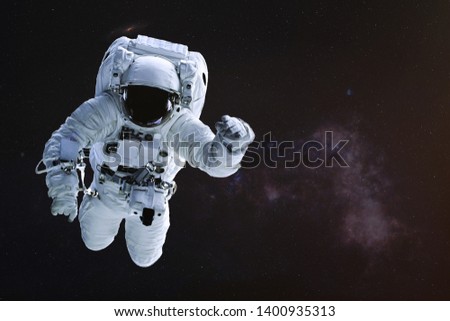Astronaut in outer space. Science fiction wallpaper. Elements of this image were furnished by NASA.