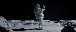 Astronaut Searching For Cellular Or Wi-fi Signal While Walking On Moon Surface