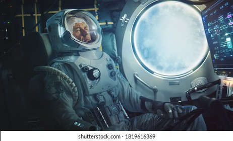 Astronaut Sitting Inside A Space Rocket During Take Off. Successful Rocket Launch Sending Space Ship Into Space. Cosmonaut Experiencing G-Force And Vibrations Inside Capsule. Clouds In Porthole.