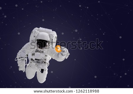 Astronaut in space holding Bitcoin. The elements of this image furnished by NASA