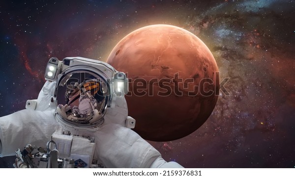 Astronaut in\
space near Mars red planet. Artemis Moon to Mars space program.\
Elements of this image furnished by\
NASA