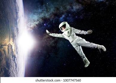 Astronaut In Space, In Zero Gravity Near The Planet Earth. The Concept Is To Find A New Earth. Elements Of This Image Furnished By NASA.