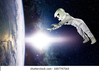 Astronaut In Space, In Zero Gravity Near The Planet Earth. The Concept Is To Find A New Earth. Elements Of This Image Furnished By NASA.