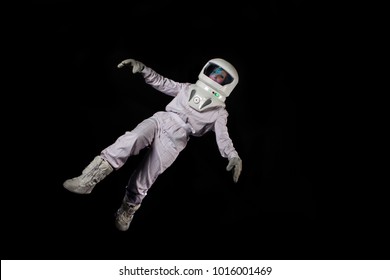 Astronaut In Space, In Zero Gravity On Black Background.