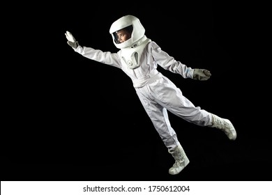 Astronaut In Space, In Zero Gravity On Black Background.