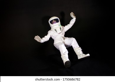 Astronaut In Space, In Zero Gravity On Black Background.