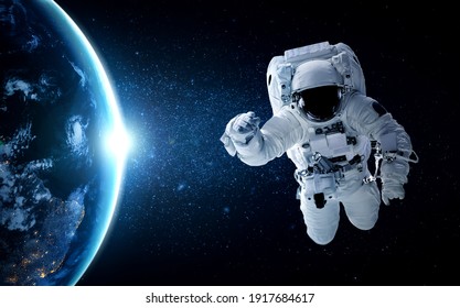 Astronaut spaceman do spacewalk while working for space station in outer space . Astronaut wear full spacesuit for space operation . Elements of this image furnished by NASA space astronaut photos. - Shutterstock ID 1917684617