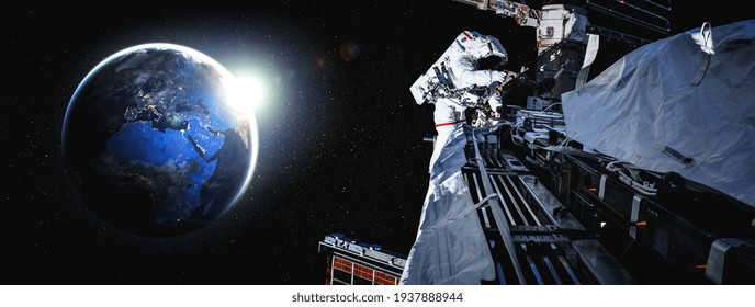 Astronaut spaceman do spacewalk while working for space station in outer space . Astronaut wear full spacesuit for space operation . Elements of this image furnished by NASA space astronaut photos.