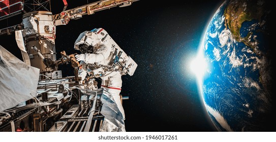 Astronaut spaceman do spacewalk while working for space station in outer space . Astronaut wear full spacesuit for space operation .  - Powered by Shutterstock - Get 15% off with code: PIKWIZARD15