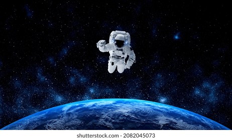 Astronaut spaceman do spacewalk while working for spaceflight mission at space station . Astronaut wear full spacesuit for operation . Elements of this image furnished by NASA space astronaut photos . - Powered by Shutterstock