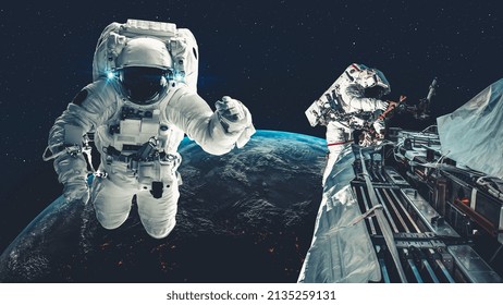 Astronaut spaceman do spacewalk while working for spaceflight mission at space station . Astronaut wear full spacesuit for operation . Elements of this image furnished by NASA space astronaut photos .