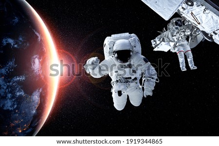 Astronaut spaceman do spacewalk while working for space station in outer space . Astronaut wear full spacesuit for space operation . Elements of this image furnished by NASA space astronaut photos.