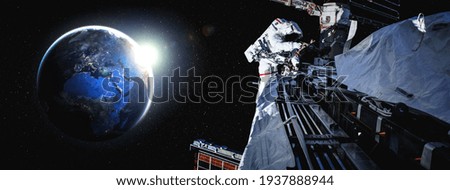 Astronaut spaceman do spacewalk while working for space station in outer space . Astronaut wear full spacesuit for space operation . Elements of this image furnished by NASA space astronaut photos.