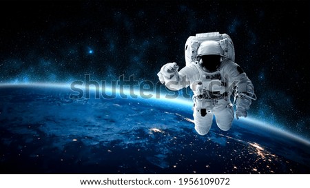 Astronaut spaceman do spacewalk while working for space station in outer space . Astronaut wear full spacesuit for space operation . Elements of this image furnished by NASA space astronaut photos.