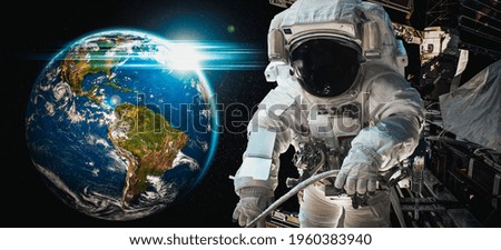 Astronaut spaceman do spacewalk while working for space station in outer space . Astronaut wear full spacesuit for space operation . Elements of this image furnished by NASA space astronaut photos.