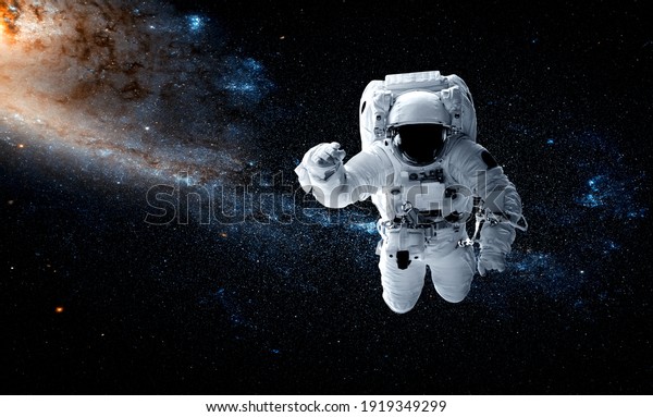 Astronaut spaceman do spacewalk while working for
space station in outer space . Astronaut wear full spacesuit for
space operation . Elements of this image furnished by NASA space
astronaut photos.