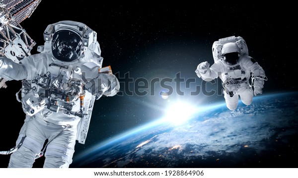 Astronaut spaceman do spacewalk while working for
space station in outer space . Astronaut wear full spacesuit for
space operation . Elements of this image furnished by NASA space
astronaut photos.