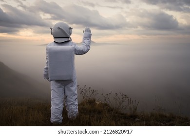 An astronaut in a spacesuit explores an unknown planet.