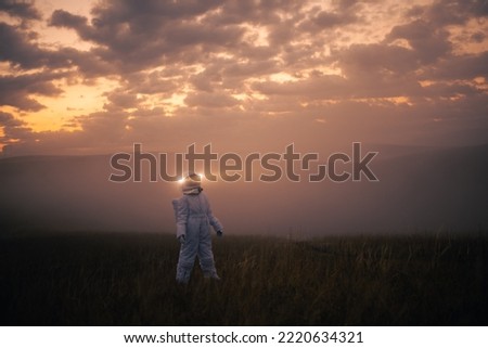 An astronaut in a spacesuit explores an unknown planet.