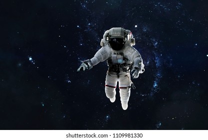 Astronaut at spacewalk, EVA, galaxy in deep space. Elements of this image furnished by NASA - Powered by Shutterstock