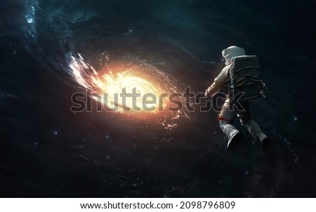 Astronaut at spacewalk looks at Milky Way galaxy. Elements of image provided by Nasa