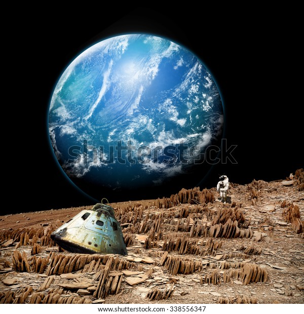 An astronaut surveys his situation after being\
marooned on a barren and rocky moon. An alien, and water covered\
planet,  shines in the background. - Elements of this image\
furnished by NASA.