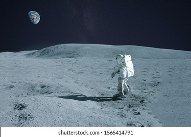 Astronaut Is Walking On The Moon. With Land On The Horizon. Elements Of This Image Were Furnished By NASA.