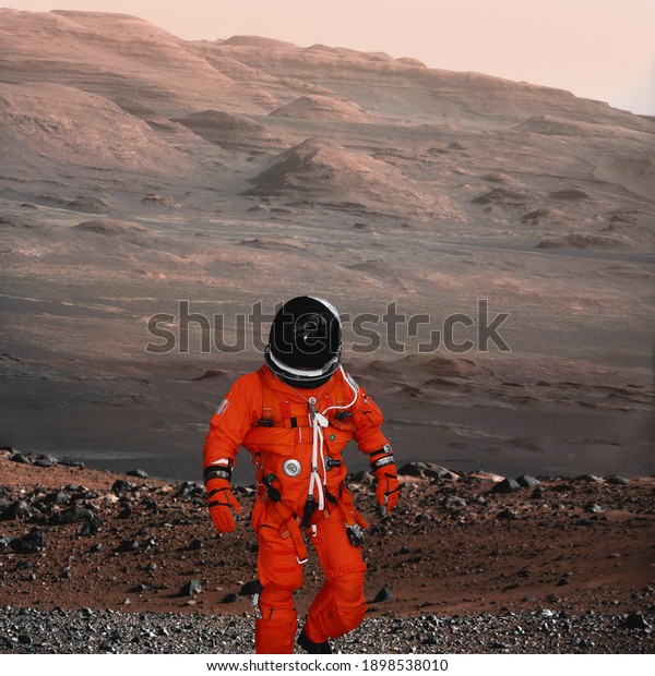 Astronaut walking on planet Mars.\
Mars travelling. The elements of this image furnished by\
NASA.\
\
