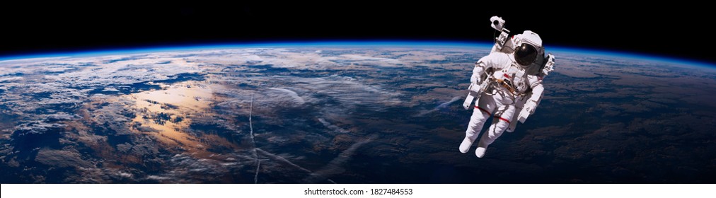 Astronaut walking in space with earth background, panorama. Elements of this image furnished by NASA.