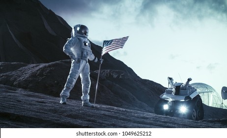 Astronaut Wearing Space Suit Plants American Flag on the Alien Planet. Patriotic and Proud Moment for the Whole of Humanity. Space Travel and Colonization Concept. - Powered by Shutterstock