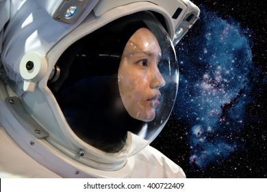 Astronaut woman on space mission with stars on the background.Portrait of a woman cosmonaut in space. Asian cosmonaut in space suit on orbit. Astronaut pioneer doing research universe.