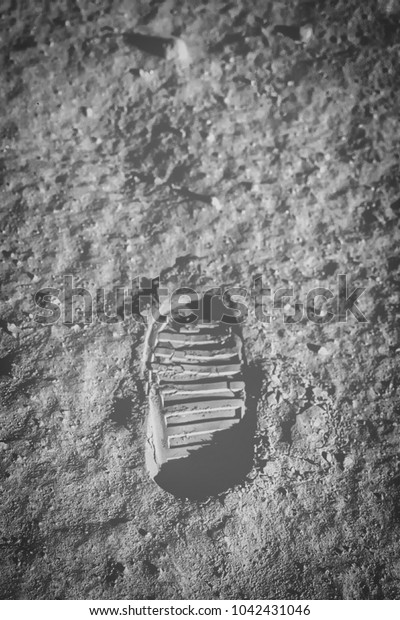 Astronaut\'s boot print on lunar moon\
landing mission. Moon Surface. Image of the Moon showing landing\
site of Apollo 11. Elements of this image furnished by\
NASA