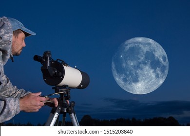 Astronomer Observes The Moon Through A Telescope. Amateur Astronomy And The Big Moon.